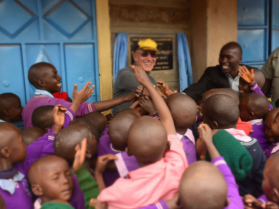 Donor and Pupils During Official Handover of a Block of Two Classrooms at AIC Gategi Compassion