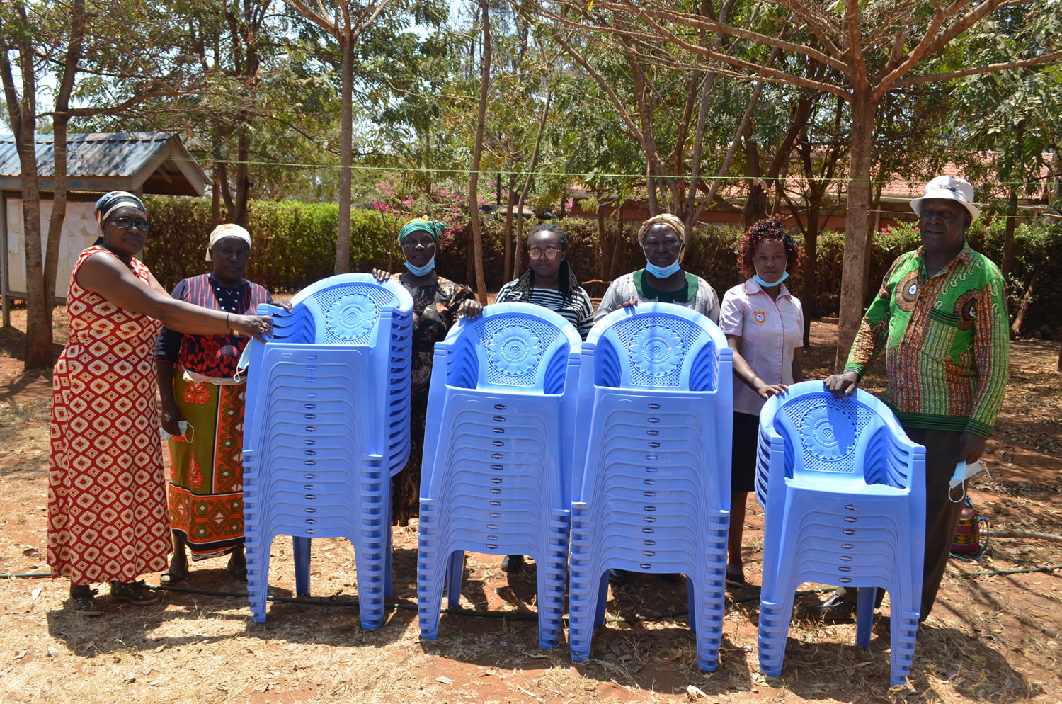 Handing over of plastic chairs to Muungano SHG